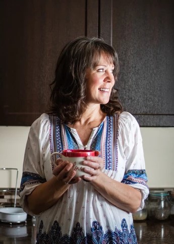 a photo of Michelle holding a cup of coffee